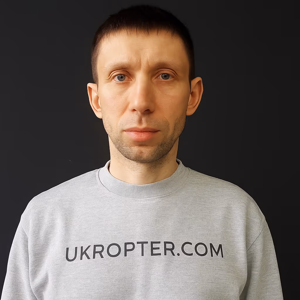 Portrait of a team member wearing a UKROPTER.COM sweatshirt, front view.
