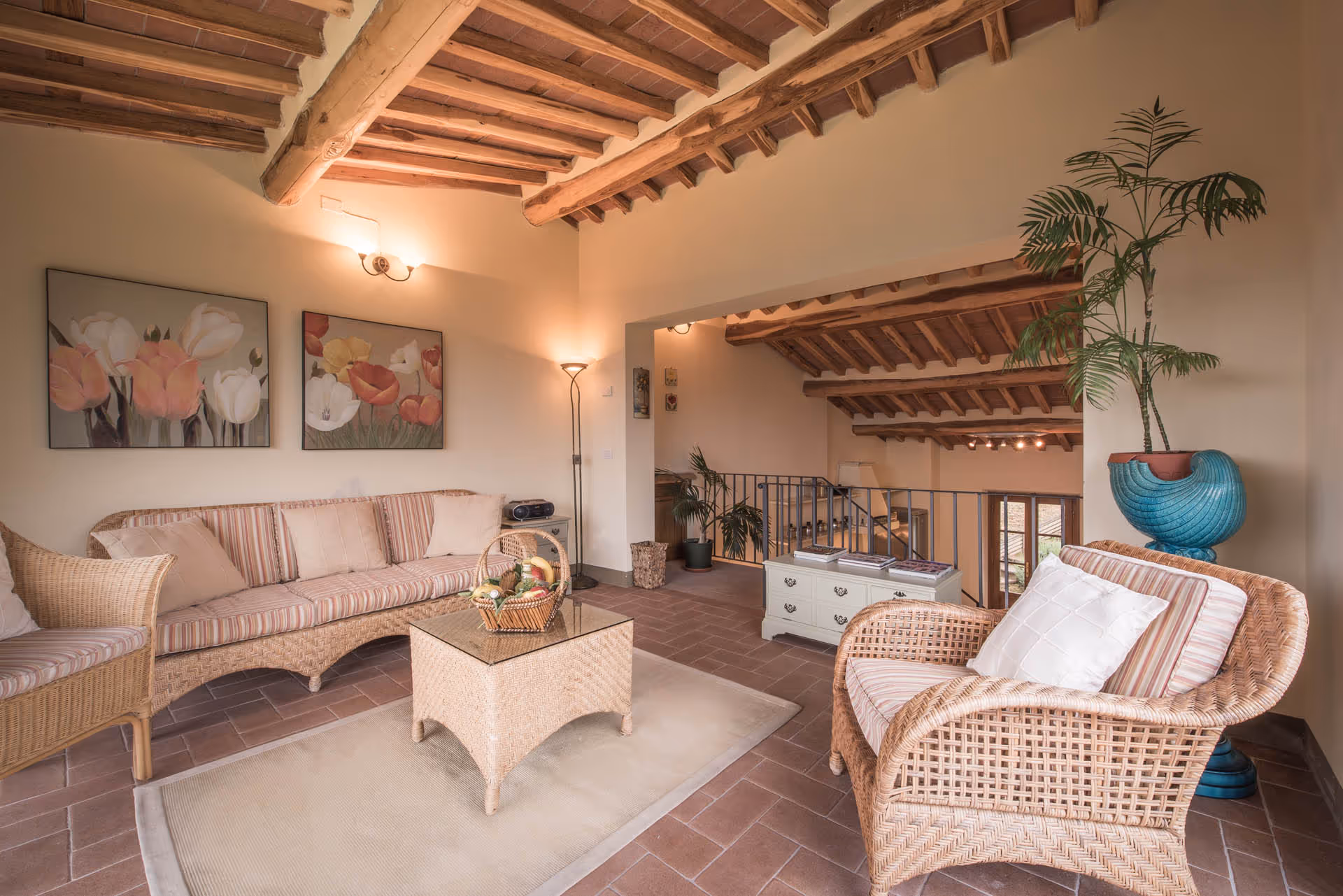 Bright garden room at the La Pianella Farmhouse with wicker furniture and Tuscan charm