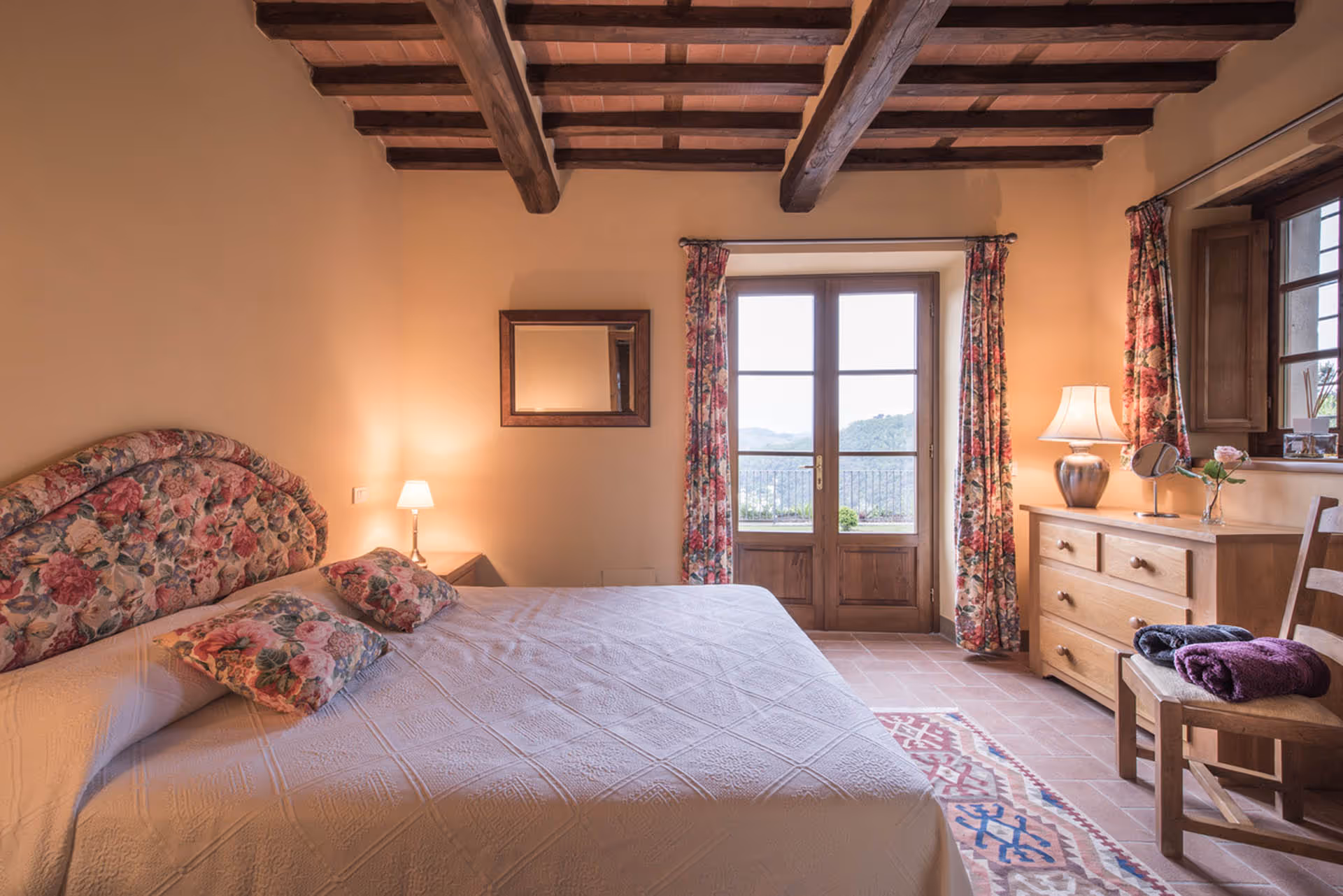 Double bedroom in the farmhouse with traditional wooden beams and countryside view
