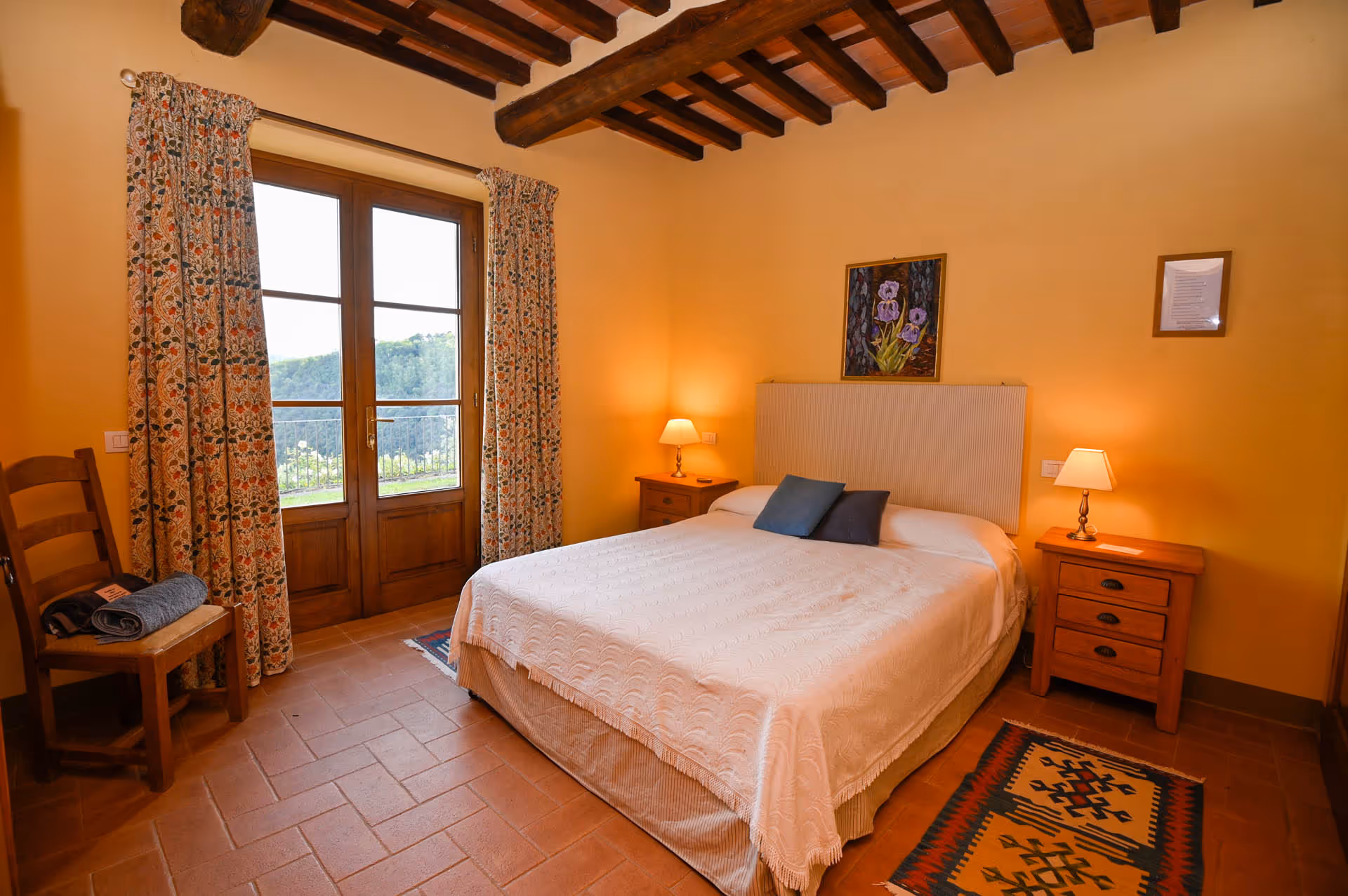 Double bedroom in the farmhouse with traditional wooden beams and countryside view