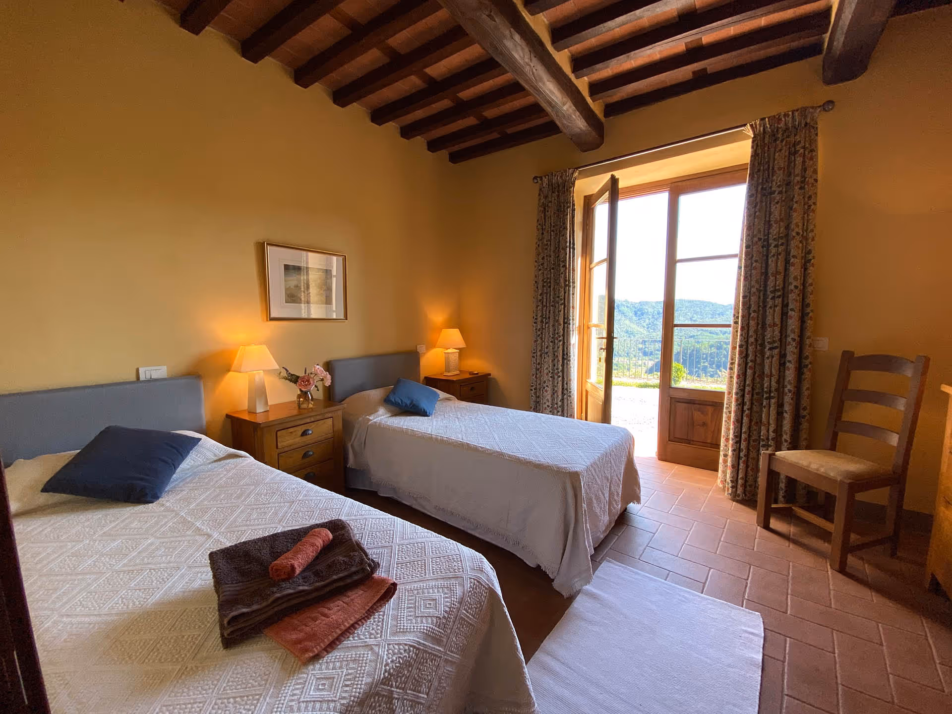 Spacious bedroom in the Tuscan farmhouse with balcony and natural light