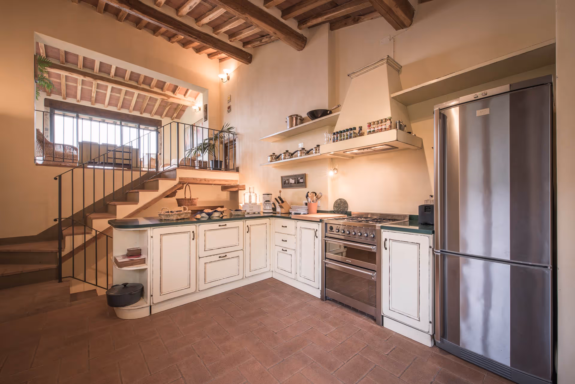 Modern farmhouse kitchen with open shelving and stone floor