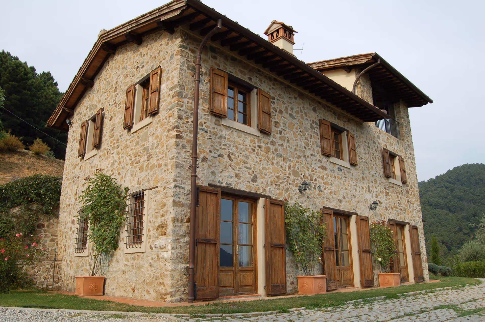 Front of the traditional stone farmhouse with wooden shutters