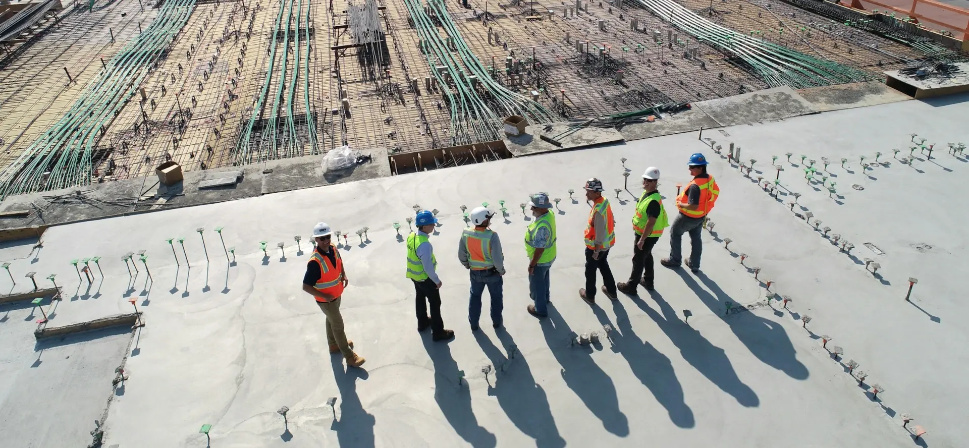 pipeline workers looking over pipe yard