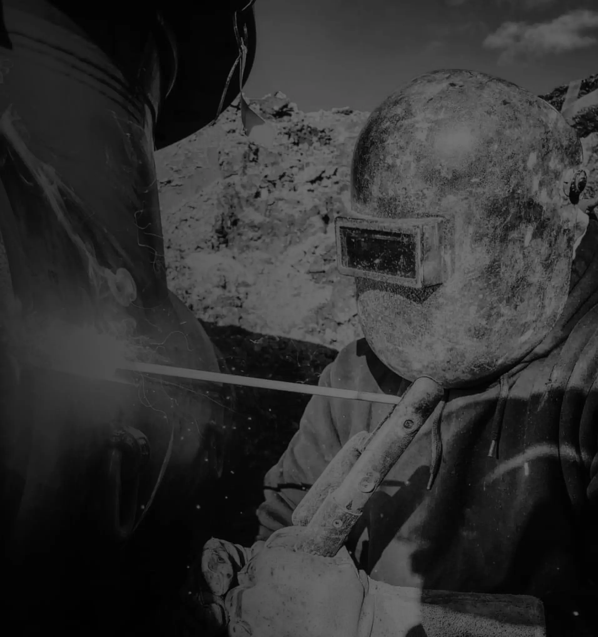 welder welding with a welding helmet on