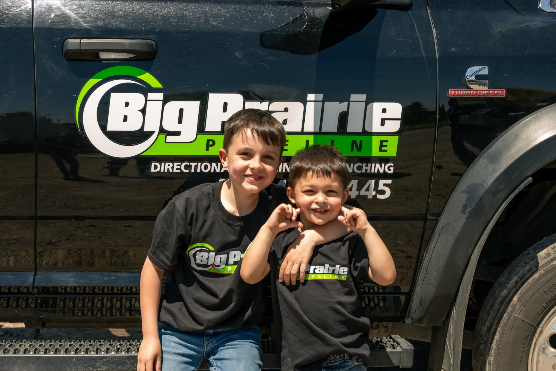 children in front of bbp logo on truck door