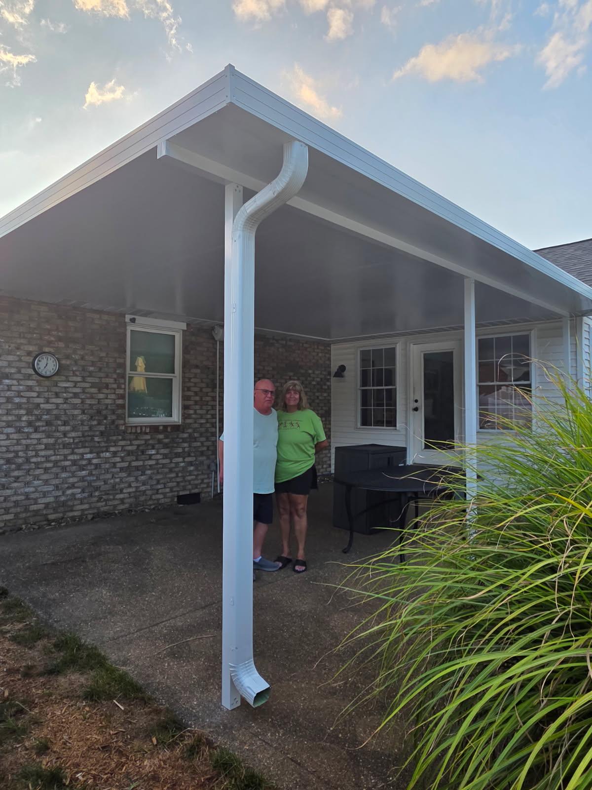 Custom white insulated aluminum patio cover built by All Weather Products in Evansville, IN, providing shade and weather protection for a brick home.