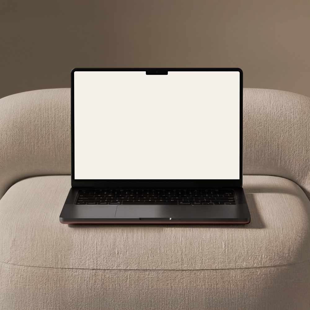 Macbook auf einem Sessel mit leerem Bildschirm. Dient als Platzhalter für zukünftige Projekt Mockups