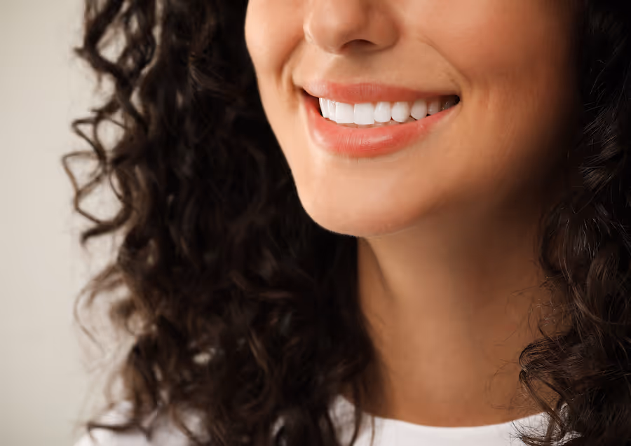 A close up of a woman smiling.