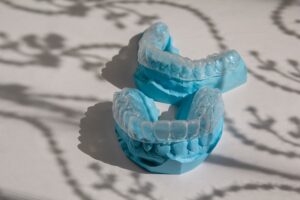 Invisible invisalign on blue fake teeth