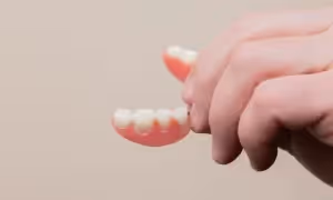 hand holding a denture