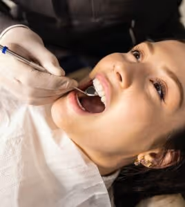 dentist in kettering, checking the health of a patient with strong dental foundations