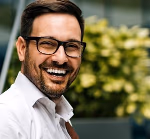 man smiling after undergoing cosmetic dental procedure