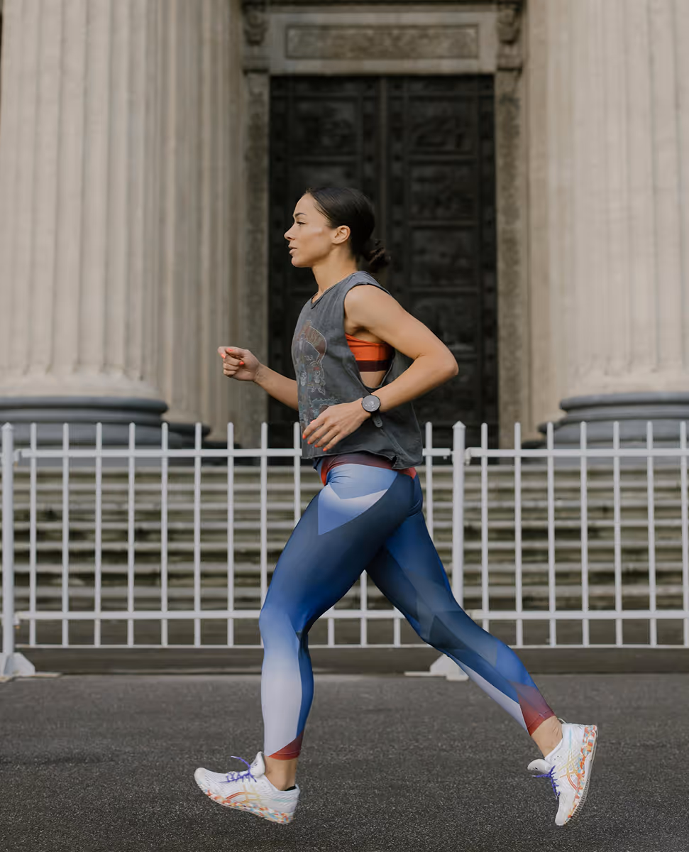 Side profile of a woman running outdoors, symbolizing clarity, momentum, and the real-life impact of using a wellness tracker like Kinētiq.