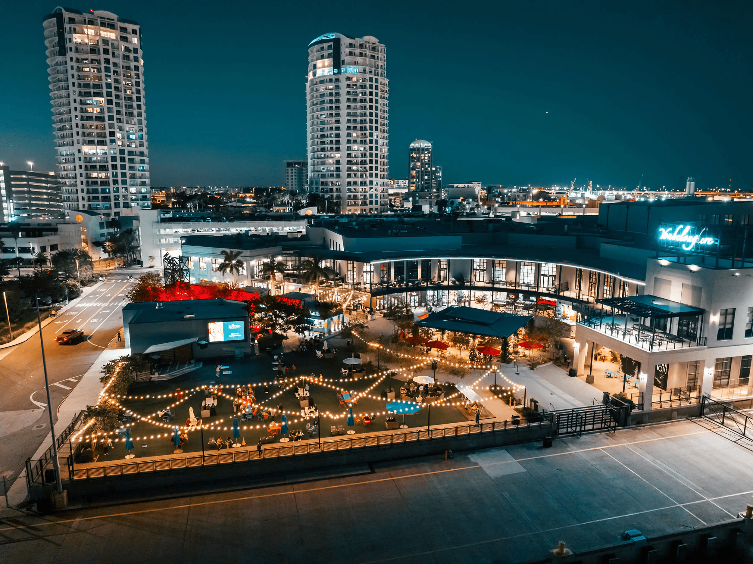 A drone shot of the Sparkman Wharf at night.