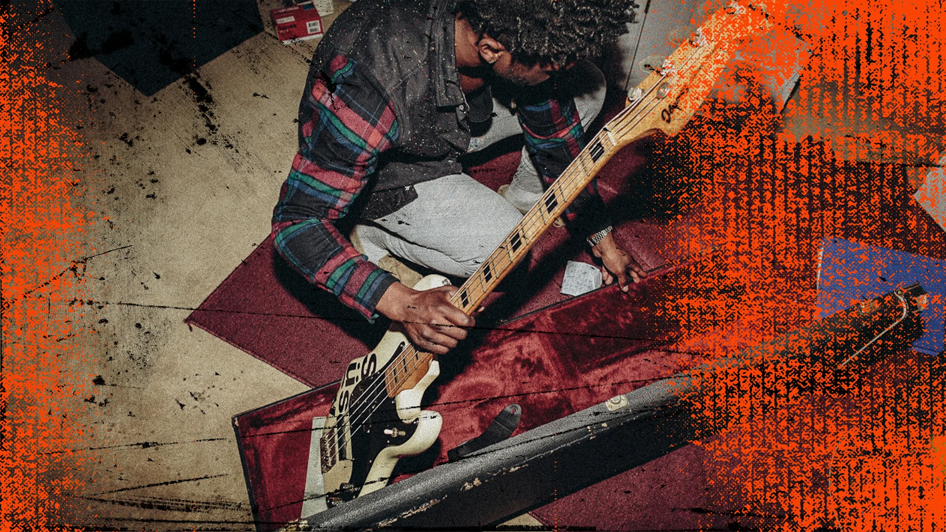 Teen boy grabbing bass guitar.