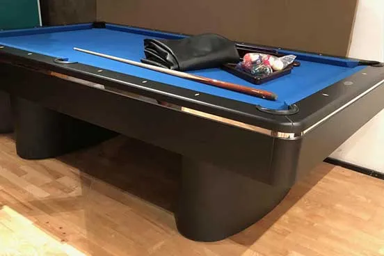 a used blue pool table with all the accessories