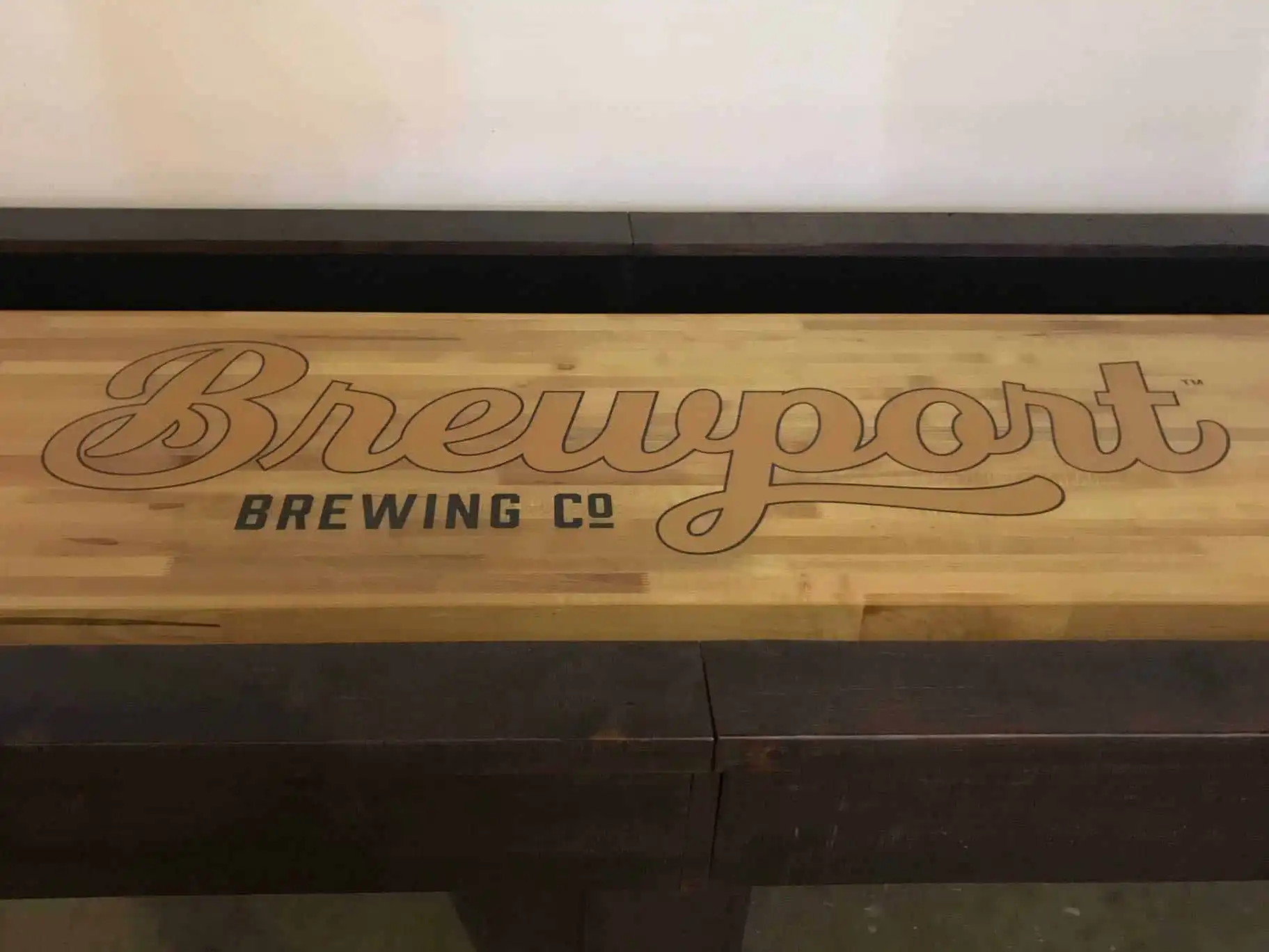 brewport custom logo on a shuffleboard table