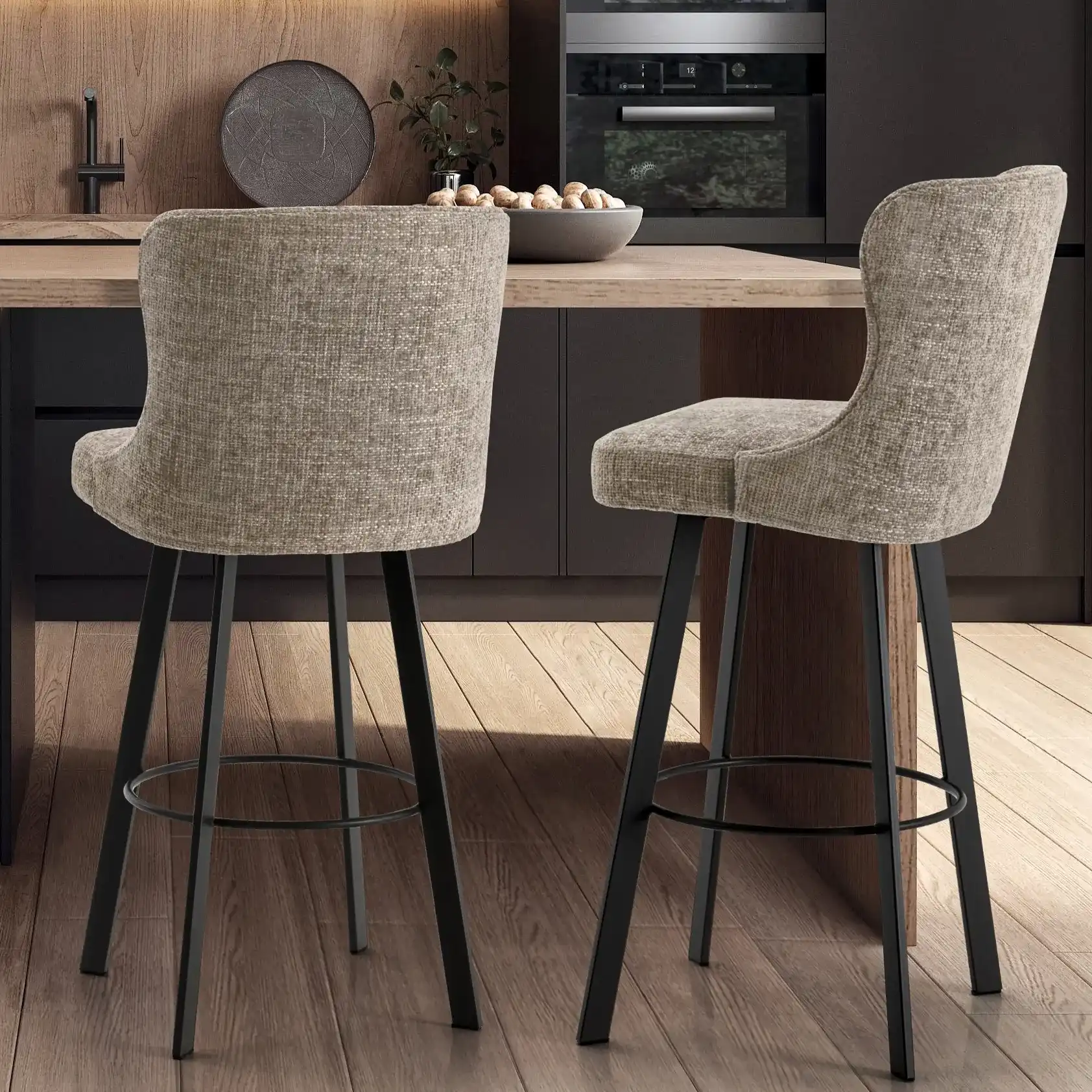 Two brown upholstered bar stools with black metal legs.