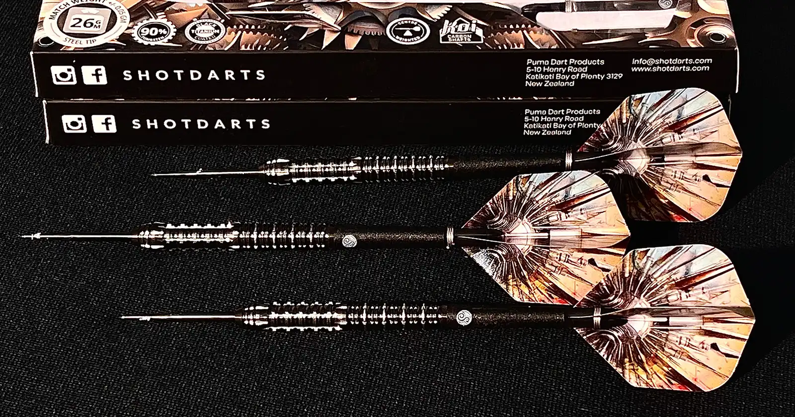 Shot Darts "Puma" darts set with steel tip and 90% tungsten barrel, displayed with packaging. Shot Darts logo and contact details visible. Ideal for serious dart players.