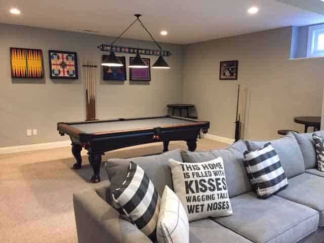 Living room with a pool table and a couch.