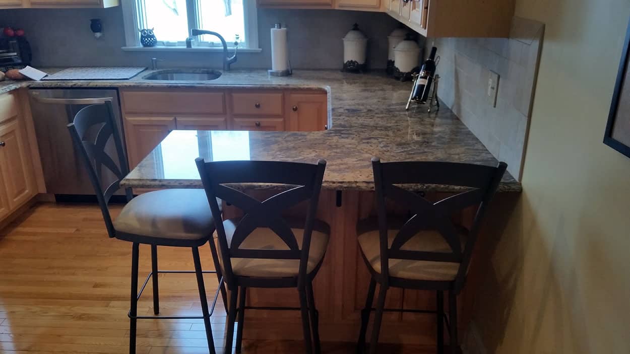 three kitchen stools at a marble counter
