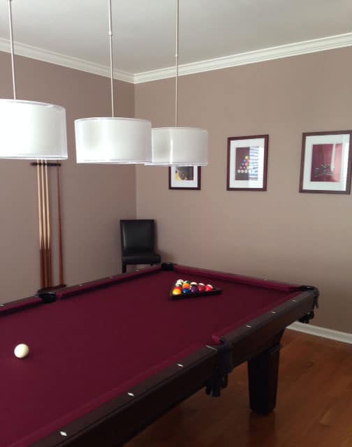 dark red maroon pool table with billiard lighting