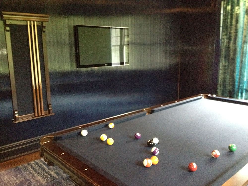black pool table and cue rack