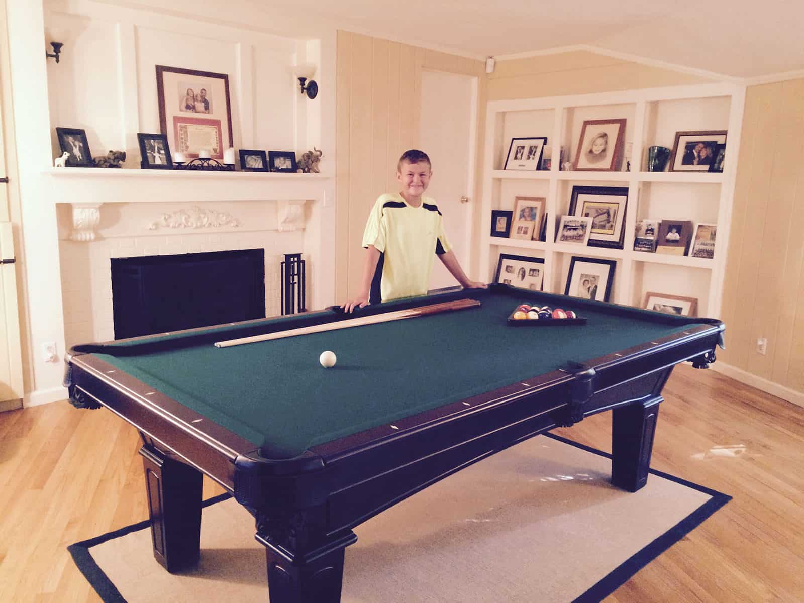 green pool table with a kid