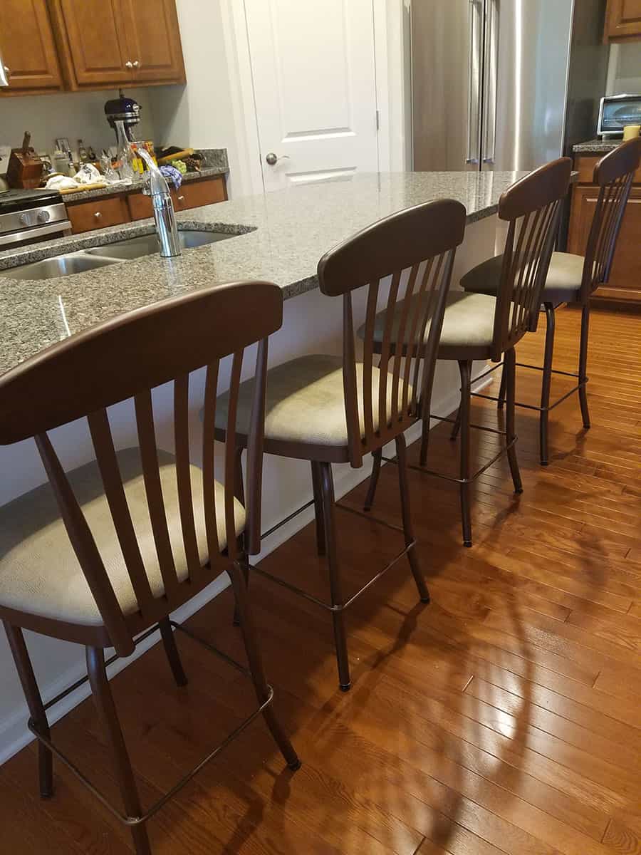 four kitchen stools at a marble counter