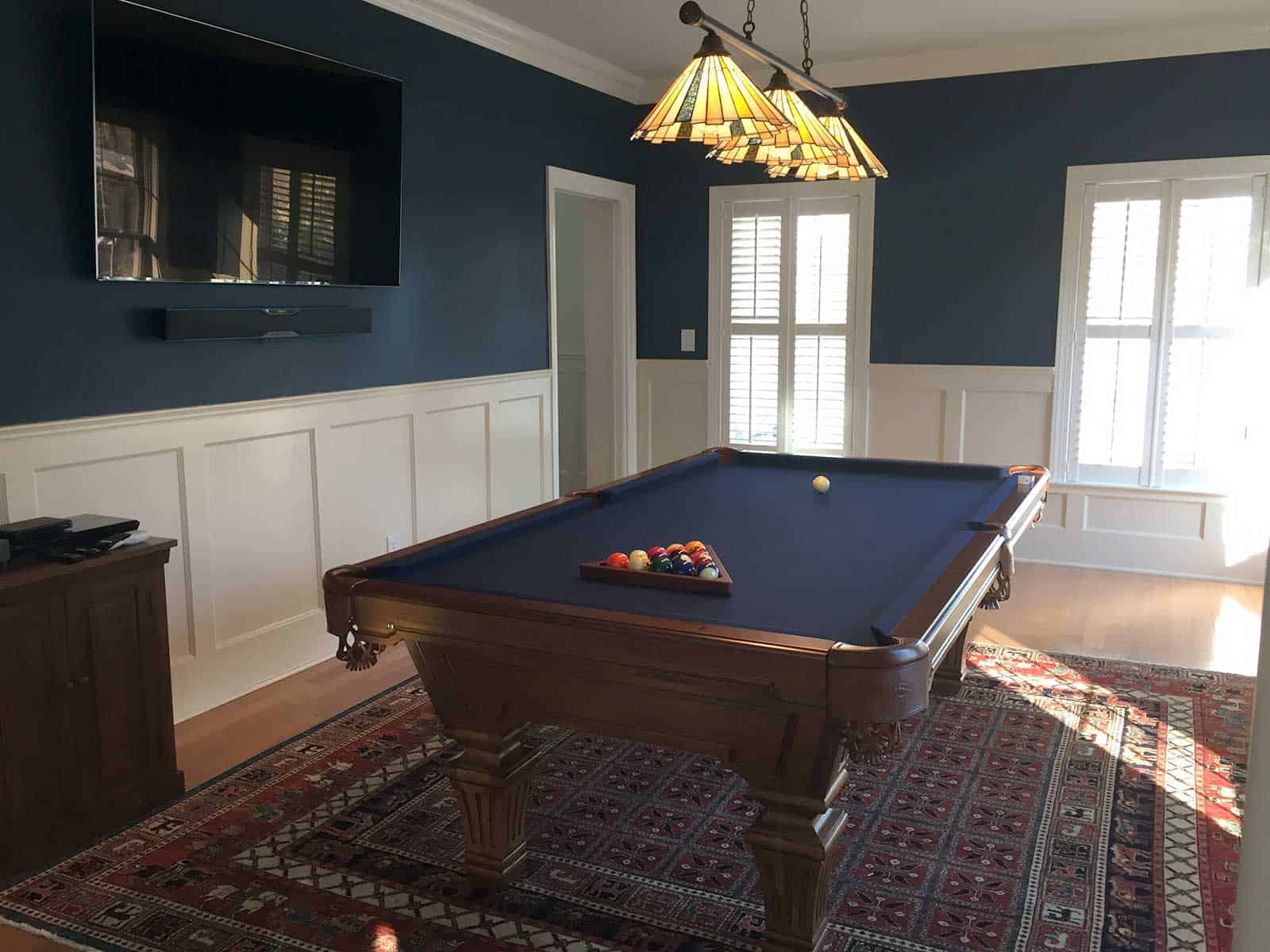 blue pool table with billiard lighting