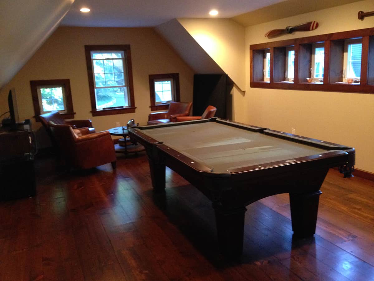 brown pool table in a yellow room