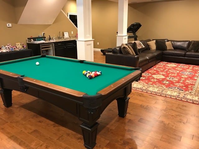 green pool table in a basement