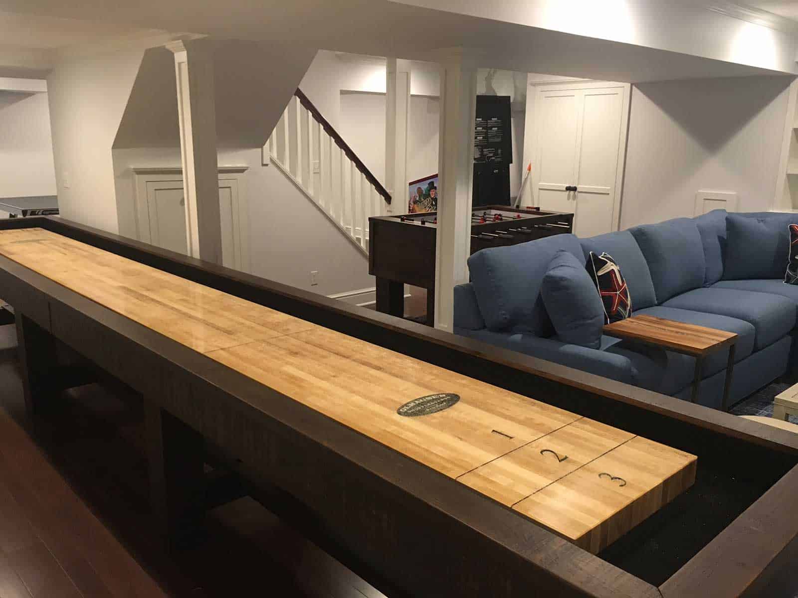 shuffleboard and foosball in a basement