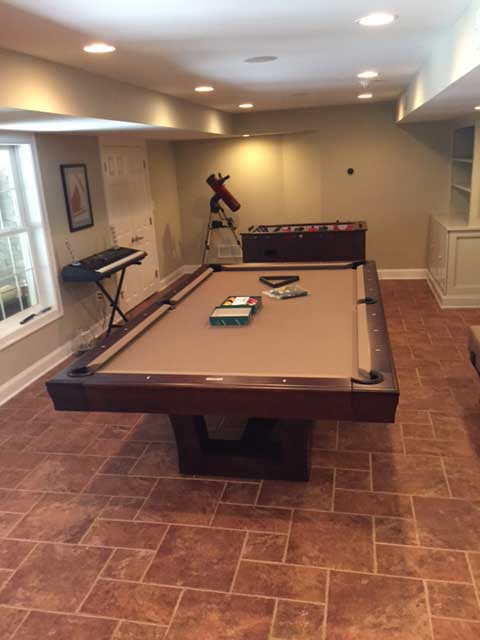 tan brown pool table with foosball, telescope and keyboard game room