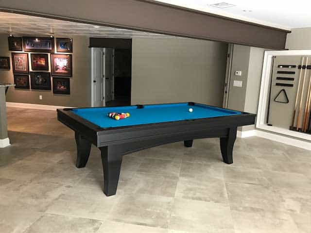 green pool table and cue rack setup