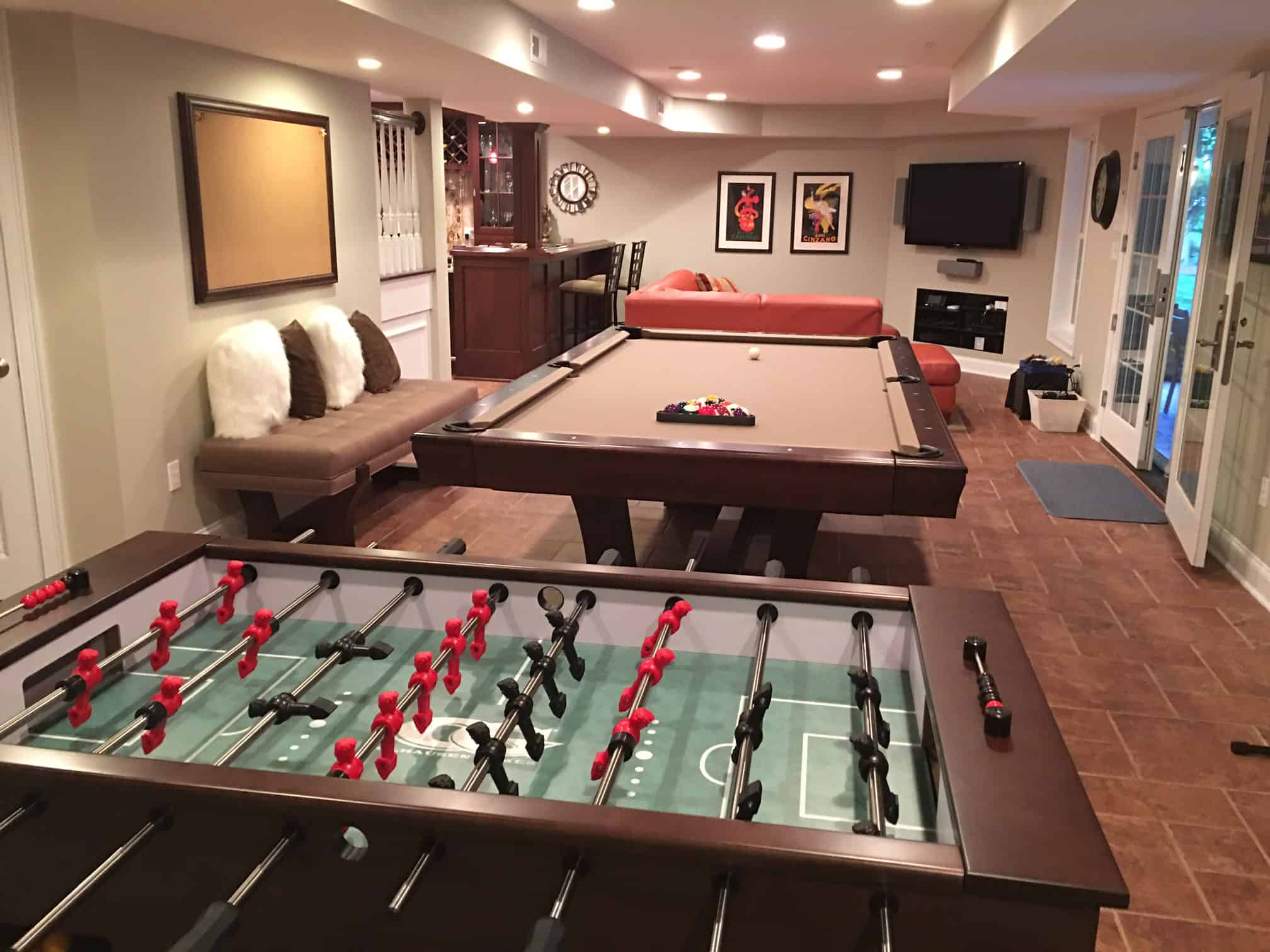 tan brown pool table and foosball