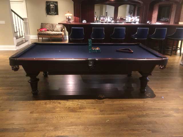 blue pool table with bar stools