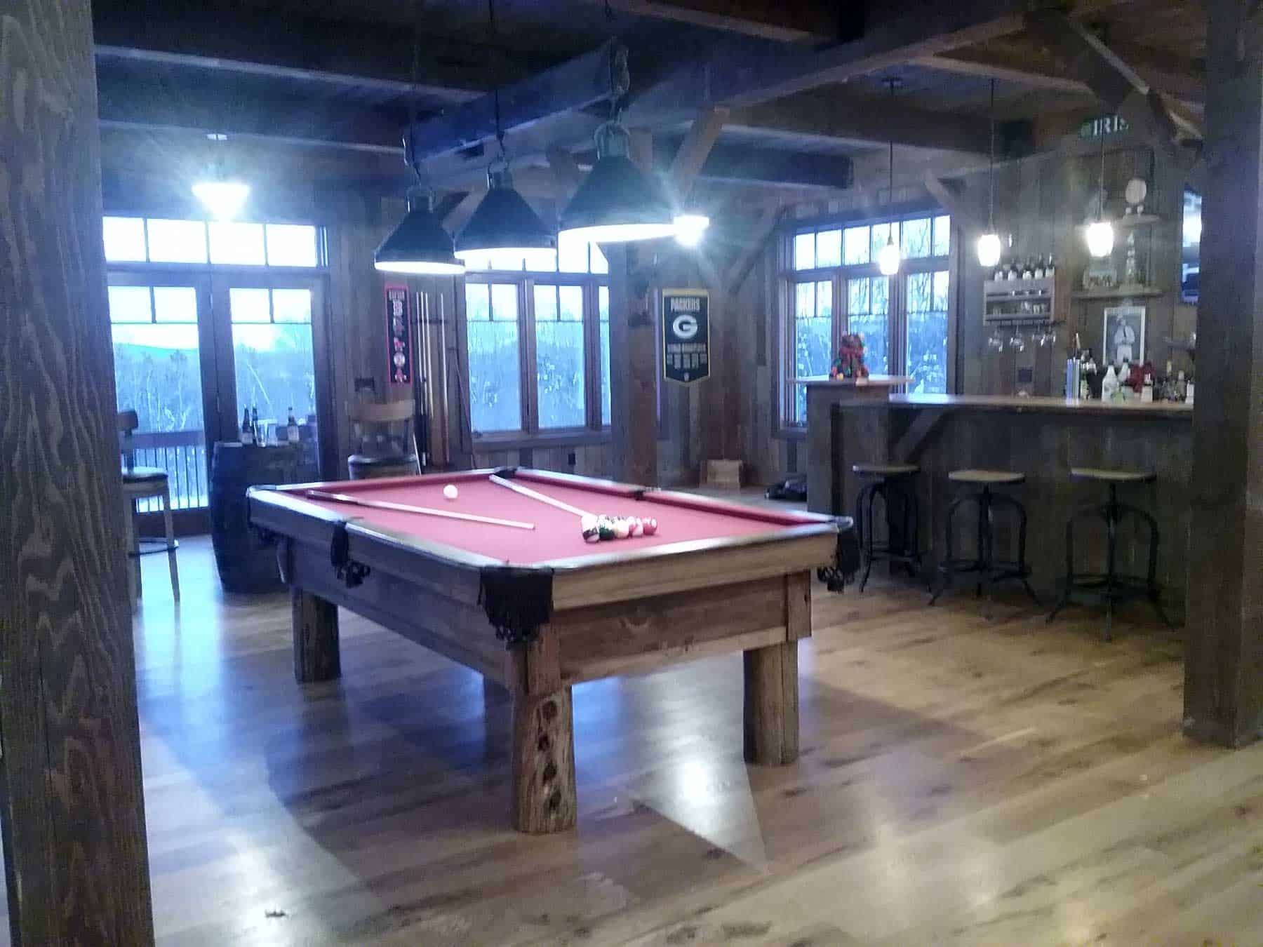 red pool table and bar stools