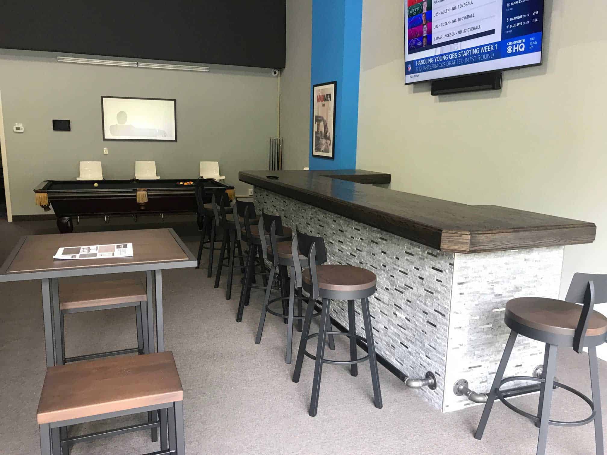 black pool table and bar stools