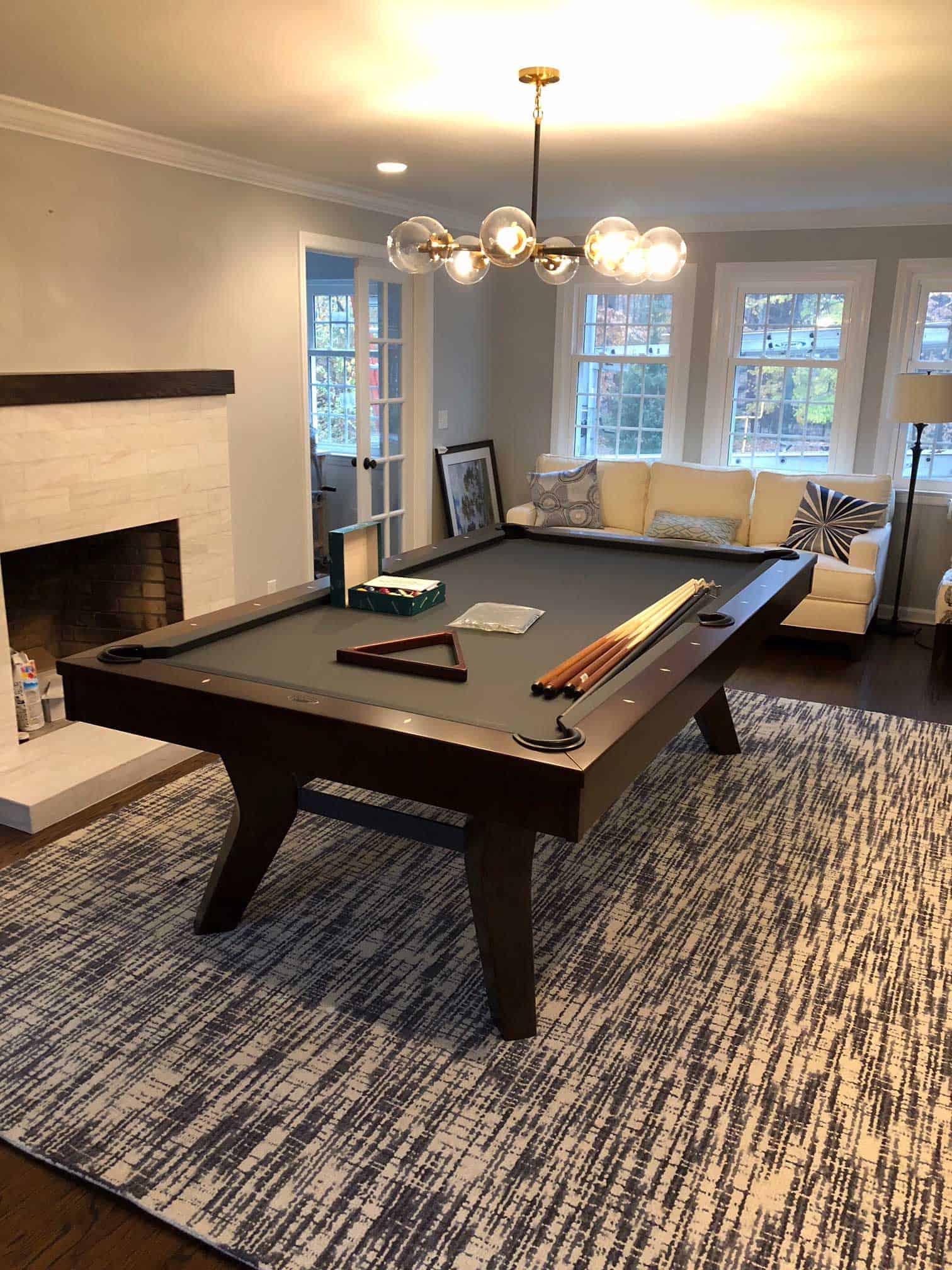 black pool table with a black and white rug