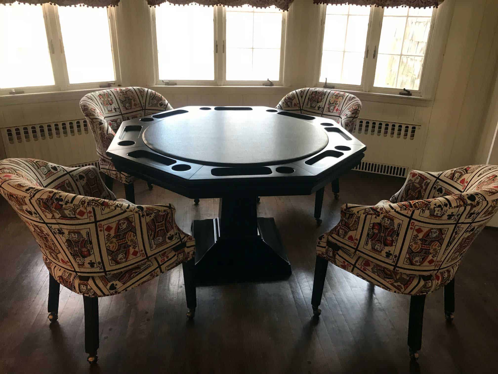 poker table with card chairs