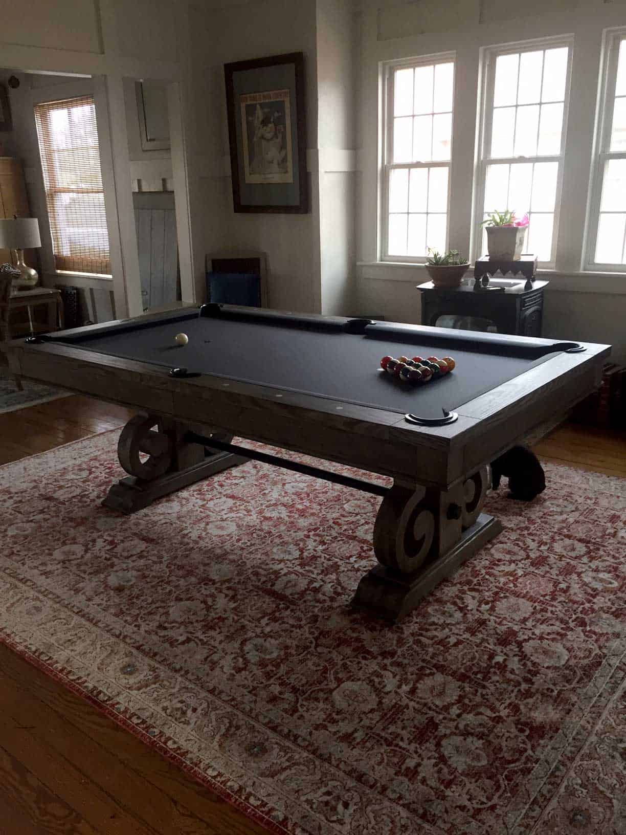blue pool table on a red rug