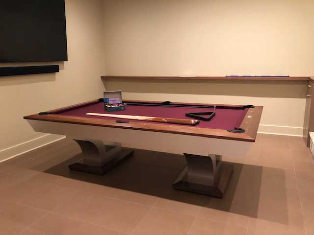red billiards table in tan room