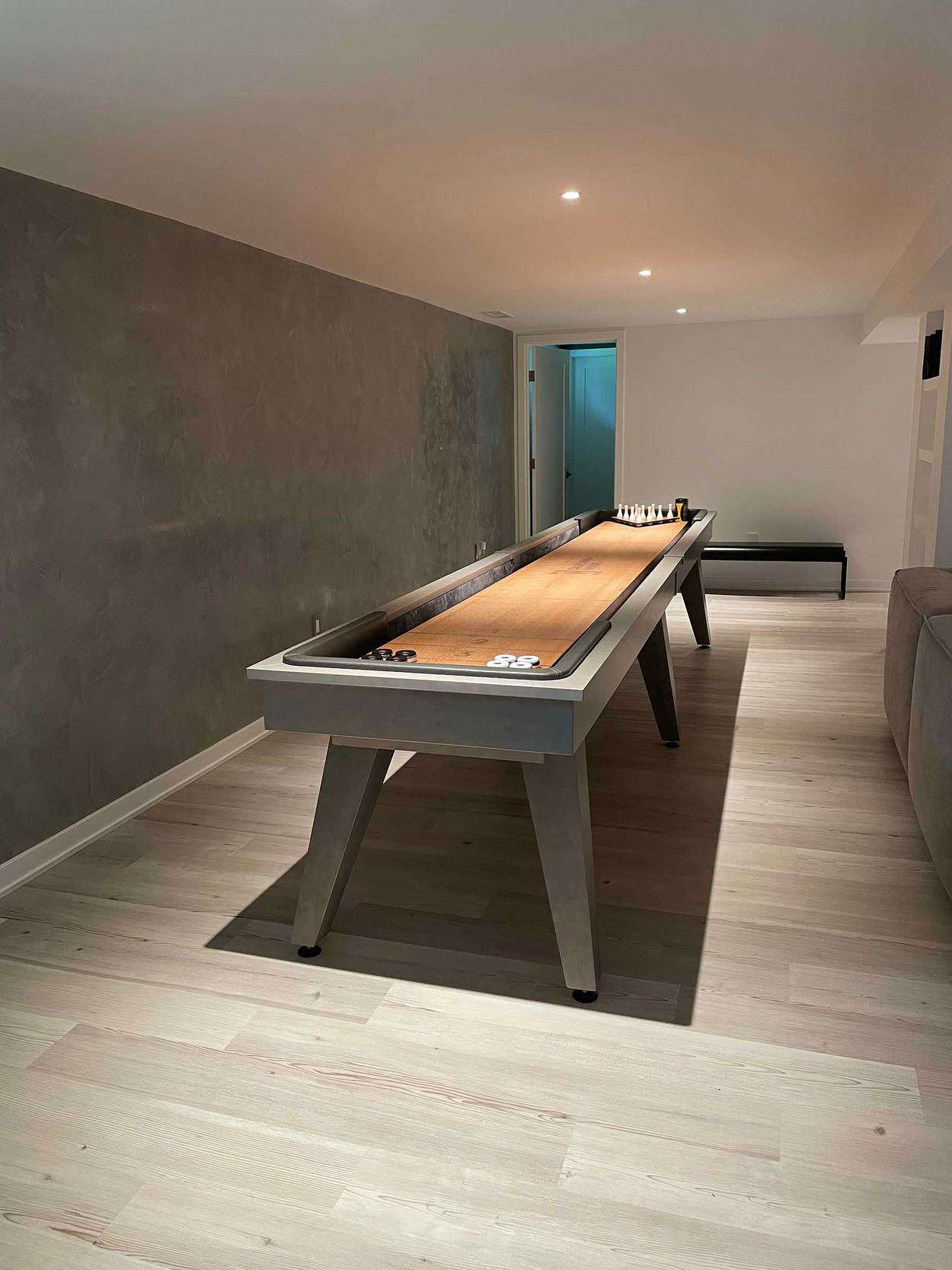 shuffleboard table in modern grey room