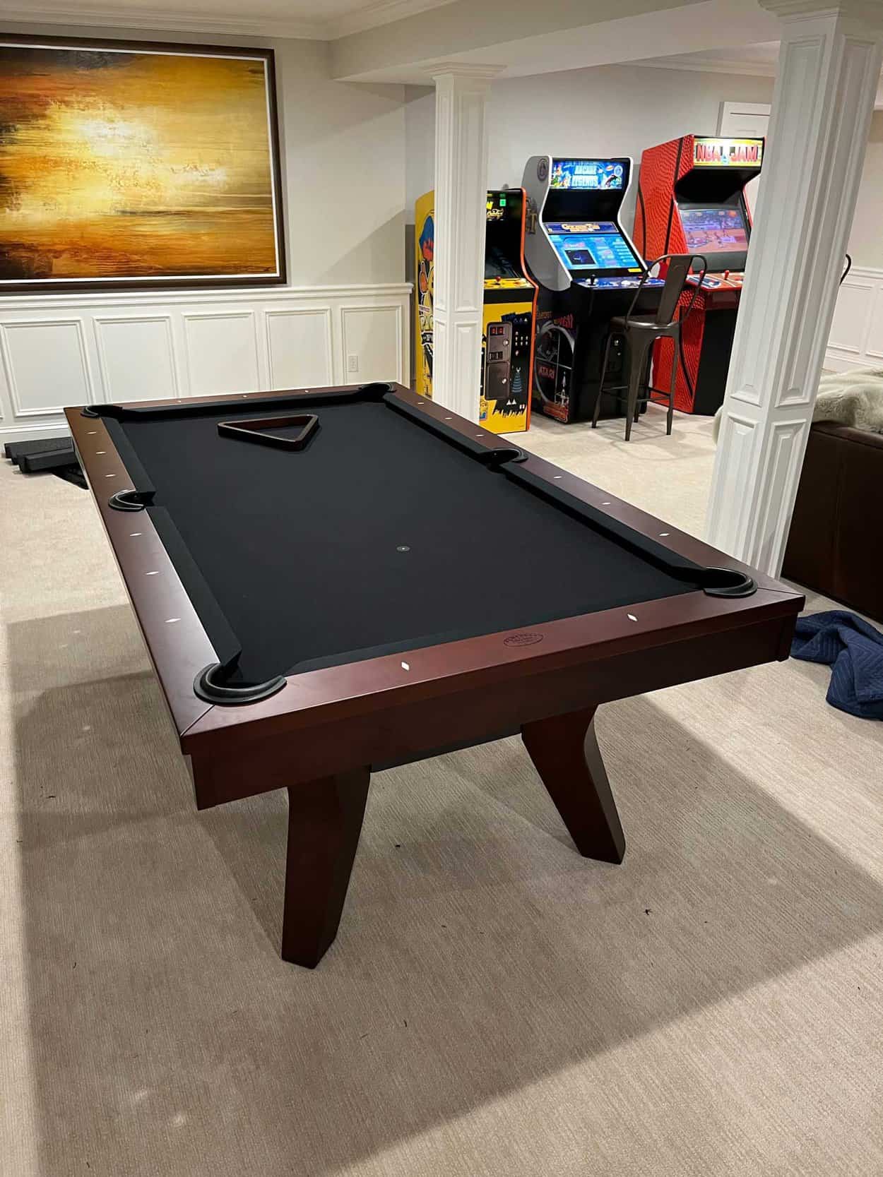 black pool table with arcade games
