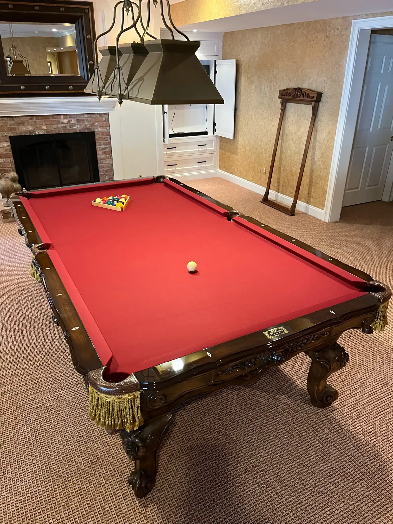 Red felt pool table with black pool lighting