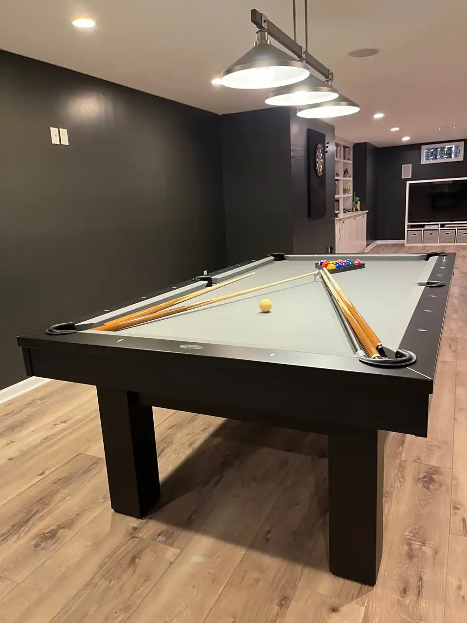 light green olhausen pool table in a room with black walls