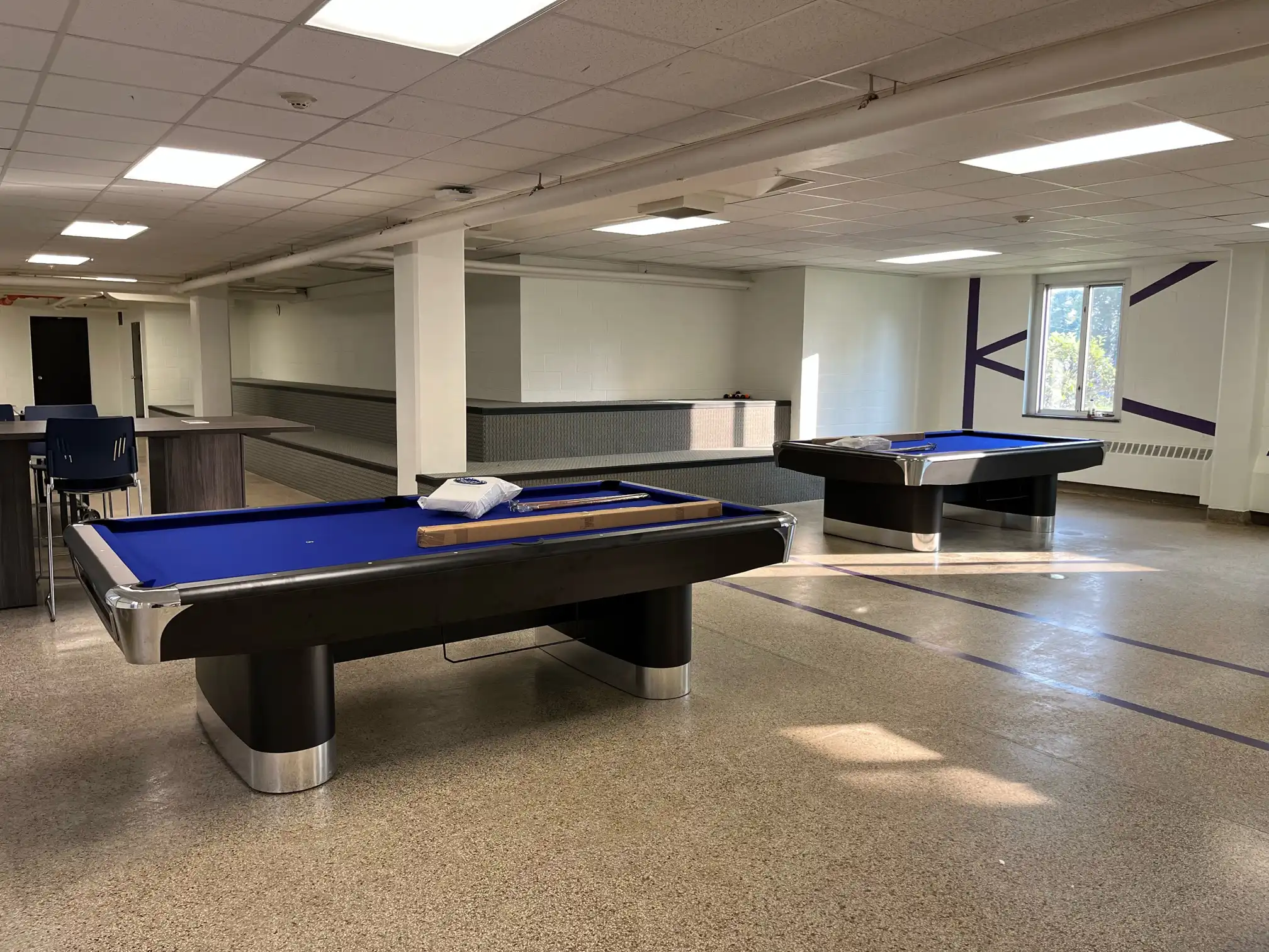 Two blue pool tables at the University of Bridgeport