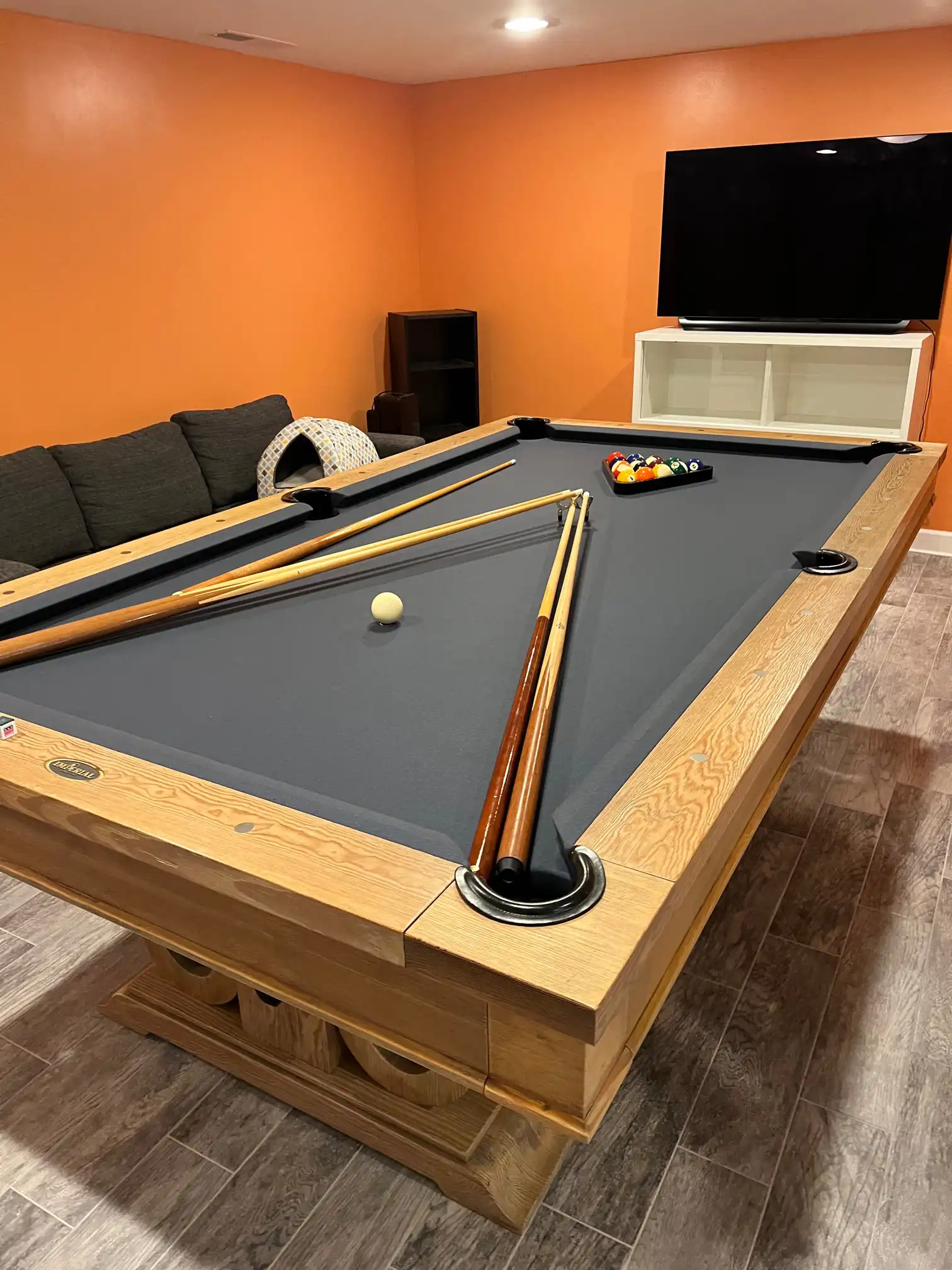 Imperial pool table in a room with orange walls